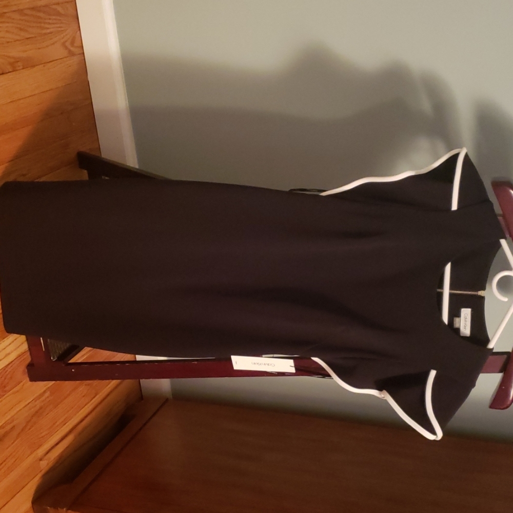 Black dress with white piping on sleeve